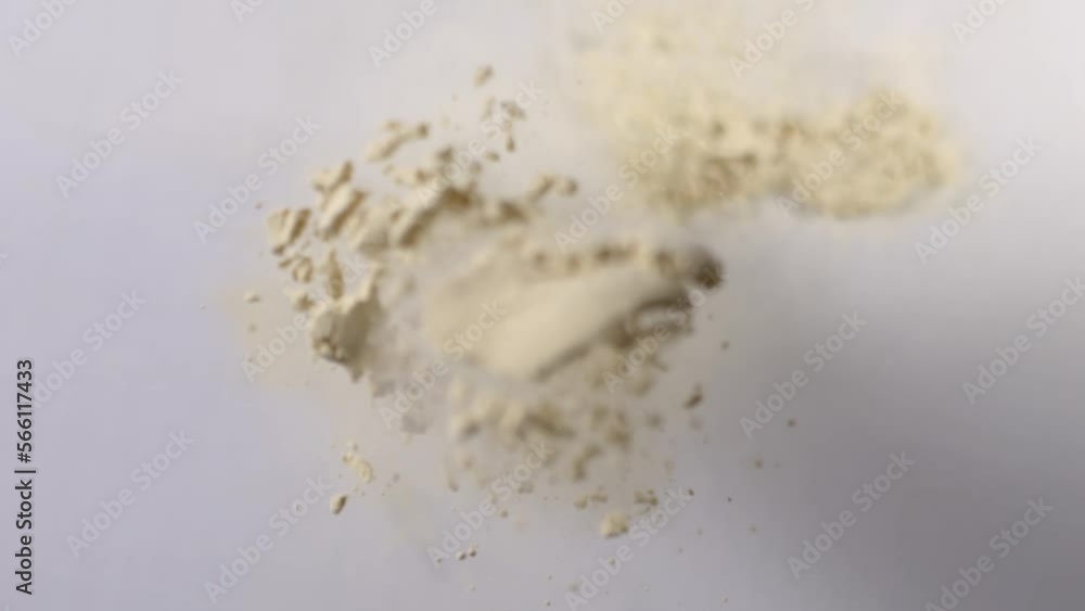 Flying Yellow Soft Pulver In Air Against White Background Flying Yellow Soft Pulver In Air Against White Background