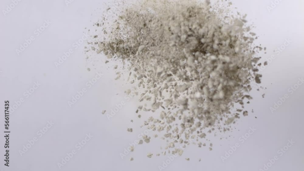 Slow Motion Shot Of Powder Flying In The Air Against White Background Slow Motion Shot Of Powder Flying In The Air Against White Background