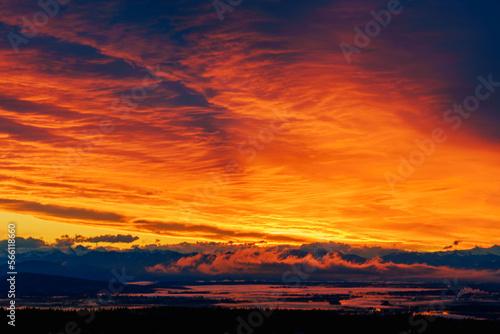 Dramatic orange winter sunrise over Fraser Valley, BC.