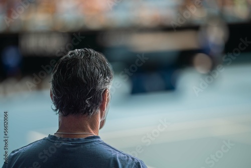 tennis fan watching a tennis match at the australian open eating food and drinking in an arena