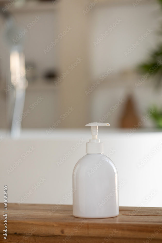 A mock-up of a white dispenser with cosmetics in bathroom. A template for a cream, shampoo or shower gel. A mock-up of a white dispenser with cosmetics in bathroom. A template for a cream, shampoo or shower gel.