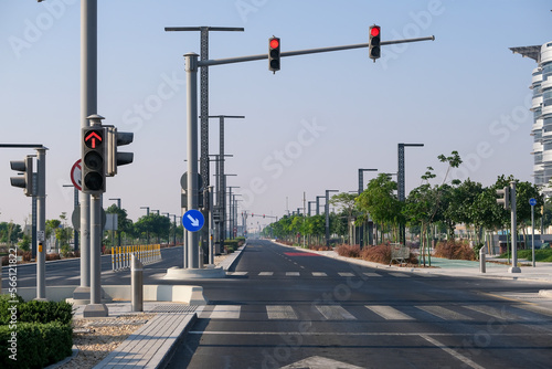 Empty highway, roadway with road sign obstacle detour right and traffic lights with red light