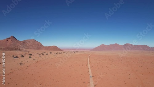 Epic drone footage in 4k of a 4x4 driving through the Namibian Desert, Tiras mountains, Southern Namibia. photo