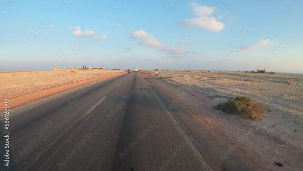 Driving on the desert road in the Sinai desert in Egypt at sunset, driver POV Driving on the desert road in the Sinai desert in Egypt at sunset, driver POV