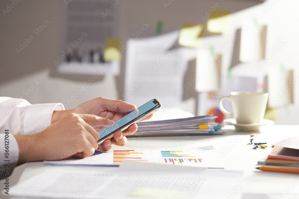 modern office desk at morning. businessman searches using smartphone. closeup modern office desk at morning. businessman searches using smartphone. closeup