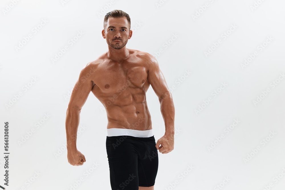 Obraz premium Man athletic body bodybuilder in briefs with naked torso abs full-length in the background, fitness classes. Advertising, sports, active lifestyle, competition, challenge concept.