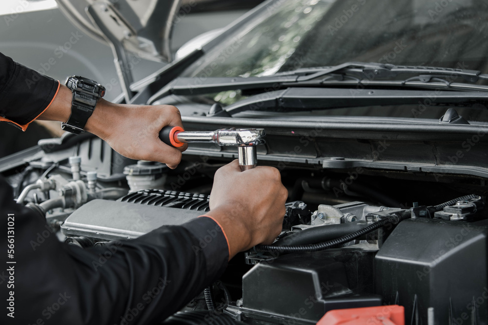 Mechanic fixing a car at home. Repair and service.