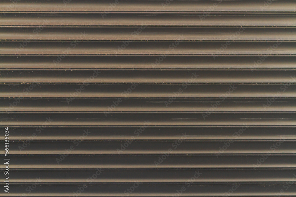 close-up of melantic gray roller shutters covering a shop window close-up of melantic gray roller shutters covering a shop window
