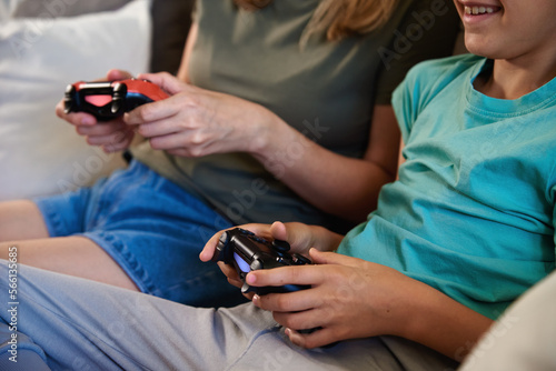 Son and mother playing video game at home, Family spending time together, Happy relationship, Online entertainment and leisure activity