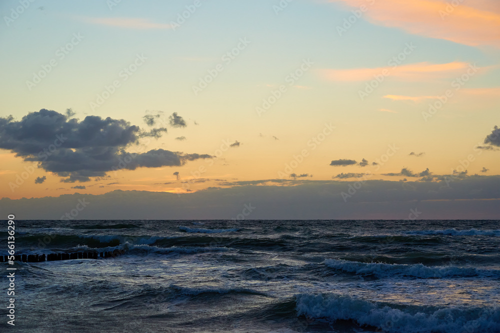 Panoramic view of sea landscape against sunset. Baltic sea coastline with waves and beautiful cloudy sky