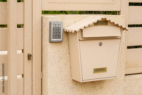 Modern fence with intercom and mailbox outdoors © Pixel-Shot