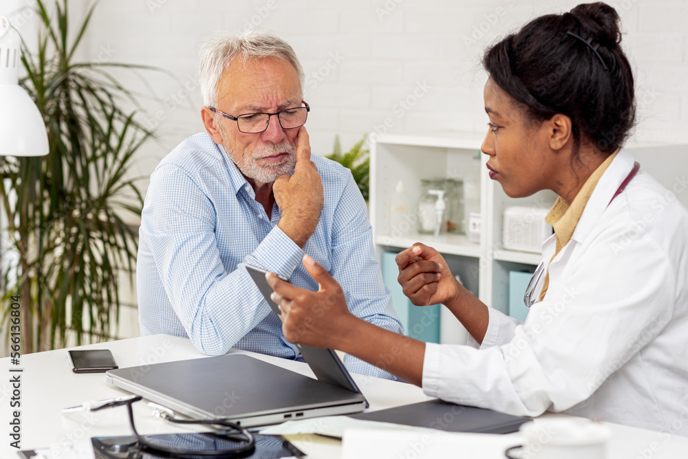 Obraz premium Depressed male senior adult in ambulance with afro american doctor. Doctor support and comforting her patient with sympathy
