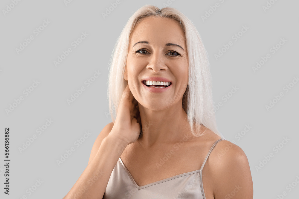 Mature blonde woman on light background Mature blonde woman on light background