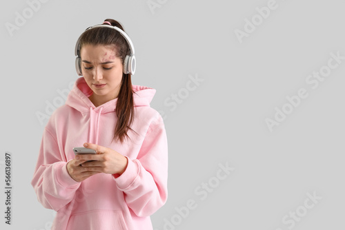 Upset Young woman in headph...