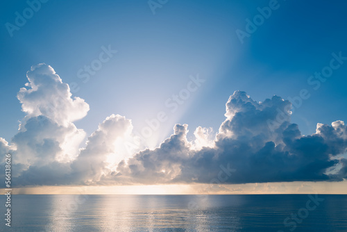 Sea sunset with cloudy sky and sun through the clouds over. Clouds Ocean and sky background, seascape.