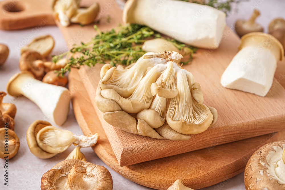 Wooden boards with fresh mushrooms on table, closeup