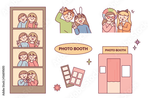 Take pictures at the photo booth. Friends and couples wearing funny headbands and doing cute poses.