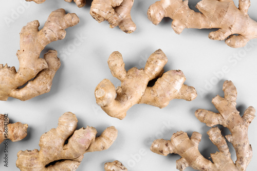 Fresh ginger roots on grey background, closeup