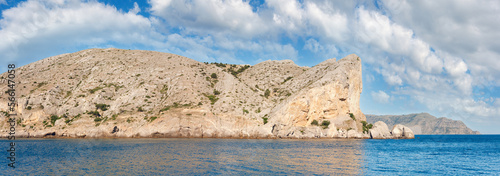 Summer rocky coastline and military base on rock top  (Alchak Cape; Sudak Town environs, Crimea, Ukraine).