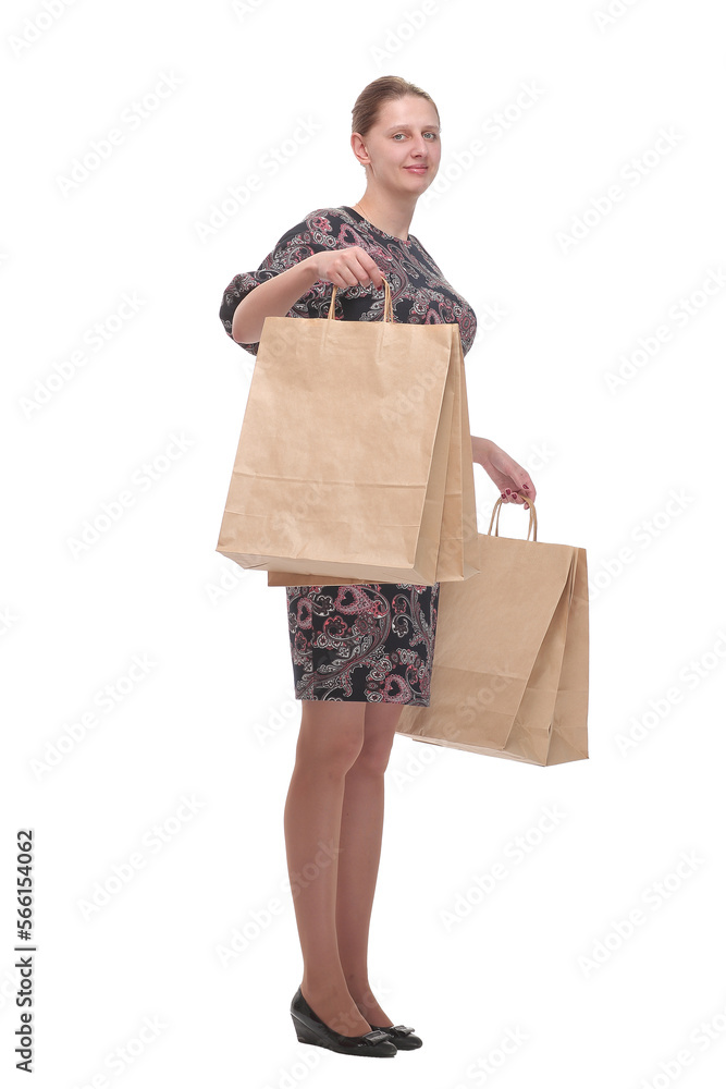 Studio portrait of a beautiful young woman, in a colourful outfit, holding in her hands a few shopping bags. Studio portrait of a beautiful young woman, in a colourful outfit, holding in her hands a few shopping bags.