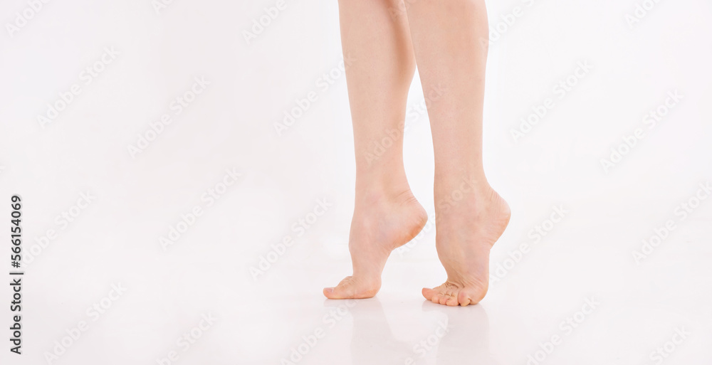 beautiful women's feet on white background. Pure white skin of the feet