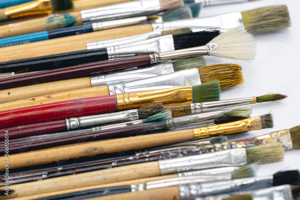 Close-up, old paint brushes on a white background. Close-up, old paint brushes on a white background.
