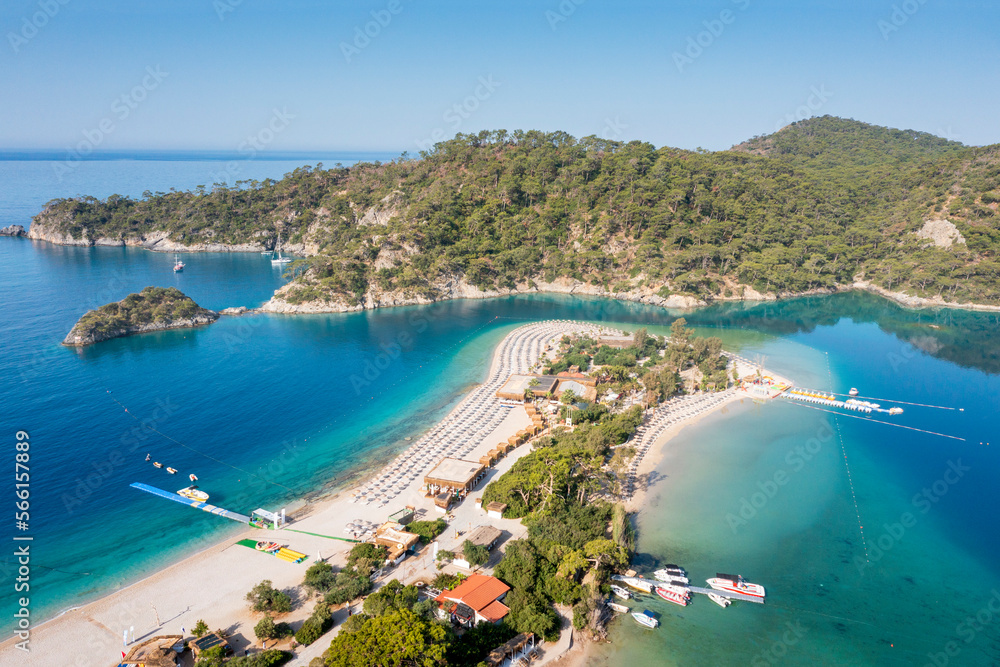 Turkey, scenic beach with white sand surrounded blue sea. Mediterranean waters near turkish coasline. Beautiful aerial view on beach of Oludeniz town. 