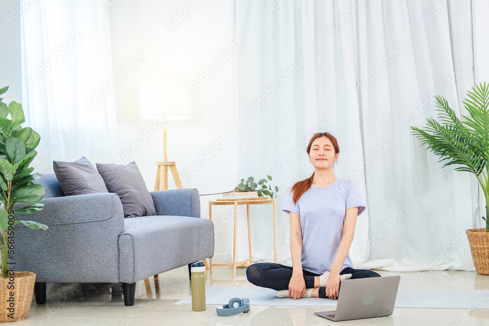 Young Asian healthy woman exercising with laptop at home Young Asian healthy woman exercising with laptop at home