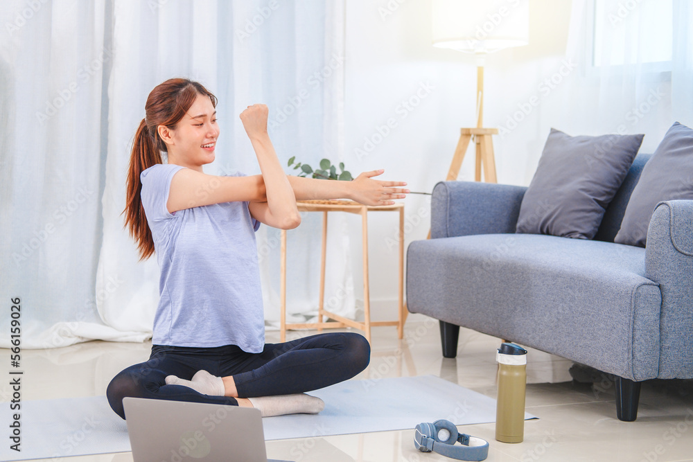 Young Asian healthy woman exercising with laptop at home Young Asian healthy woman exercising with laptop at home
