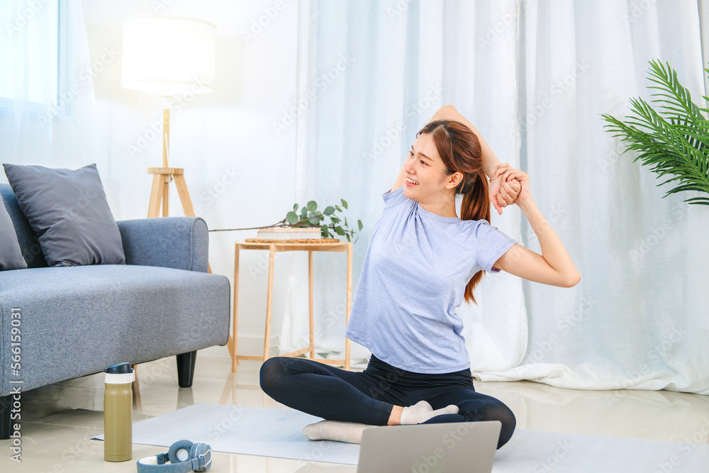 Young Asian healthy woman exercising with laptop at home Young Asian healthy woman exercising with laptop at home