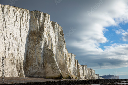 Dramatic chalk cliffs of the Seven Sisters rising above at low tide on the East Sussex coast, south east England UK