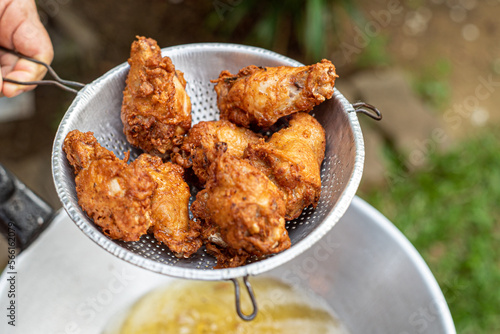 Fotografie Fries chicken with hot pan and oil.