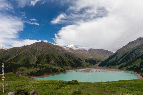 Obraz na płótnie Big Almaty Lake in summer with a view of the Peak of the Soviets under the clouds w salonie