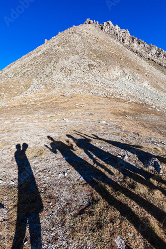 Obraz na płótnie Big Almaty peak with shadows of people on the pass. Rear view (from the side of the mountains) w salonie