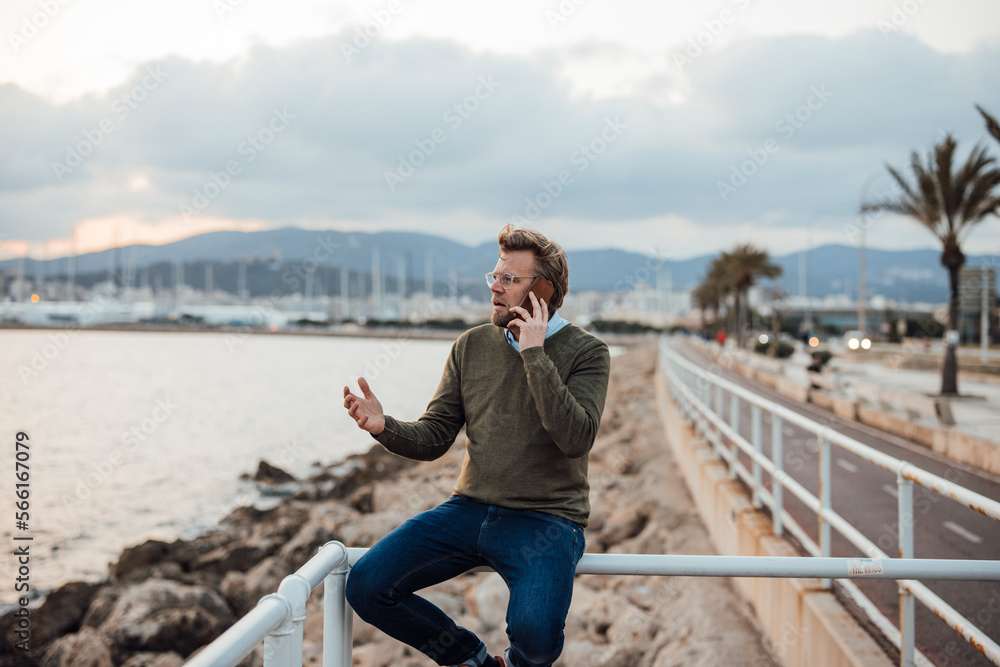 Angry mature man gesturing and talking on smart phone Angry mature man gesturing and talking on smart phone