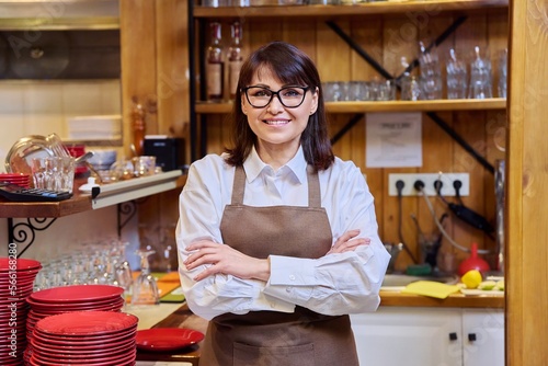 Portrait of middle aged confident woman restaurant owner