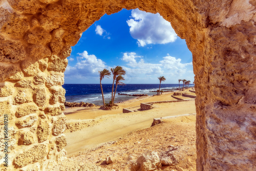 Egypt, Red Sea Governorate, Hurghada, Sandy beach of Sahl Hasheesh bay seen through stone window photo