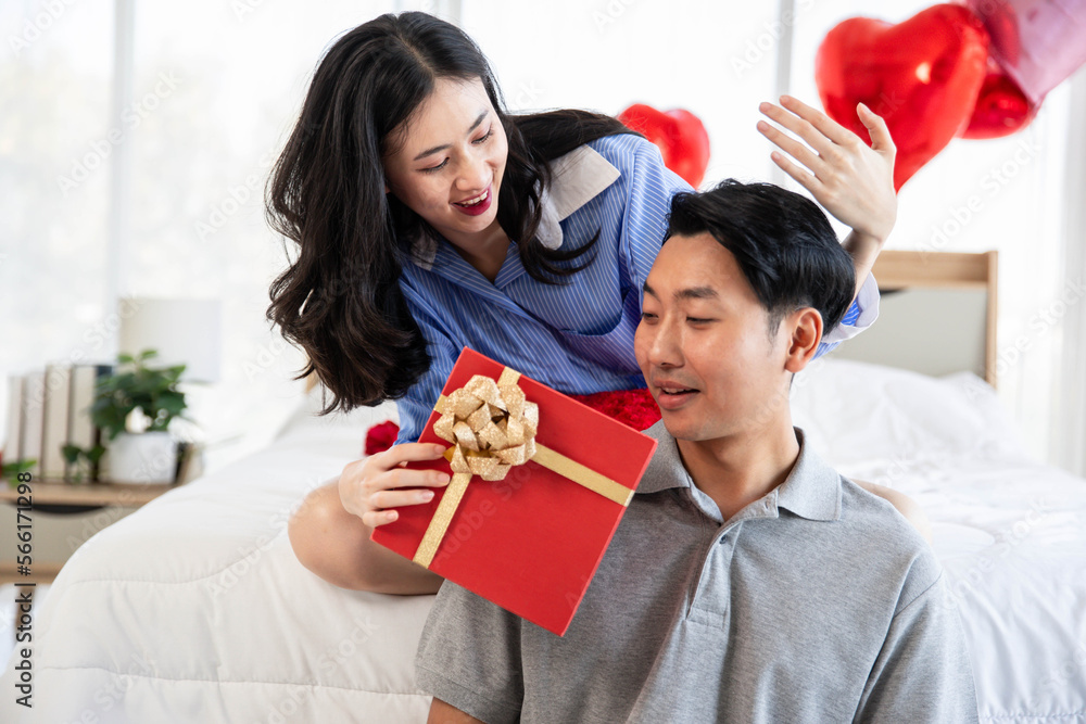 Beautiful young couple surprise with rose and gift in bedroom,Valentine's Day concept. Beautiful young couple surprise with rose and gift in bedroom,Valentine's Day concept.