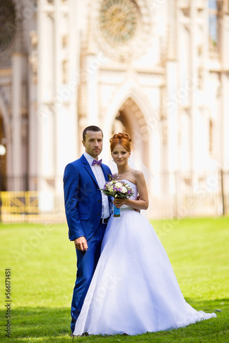 A beautiful couple poses in the park on their wedding day.