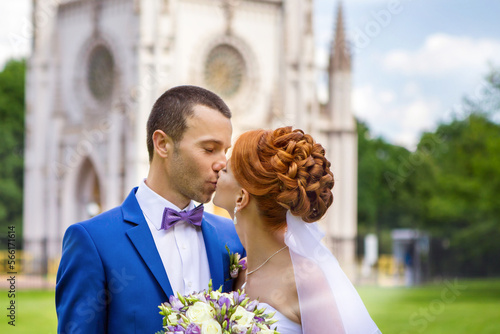 A beautiful couple poses in the park on their wedding day.