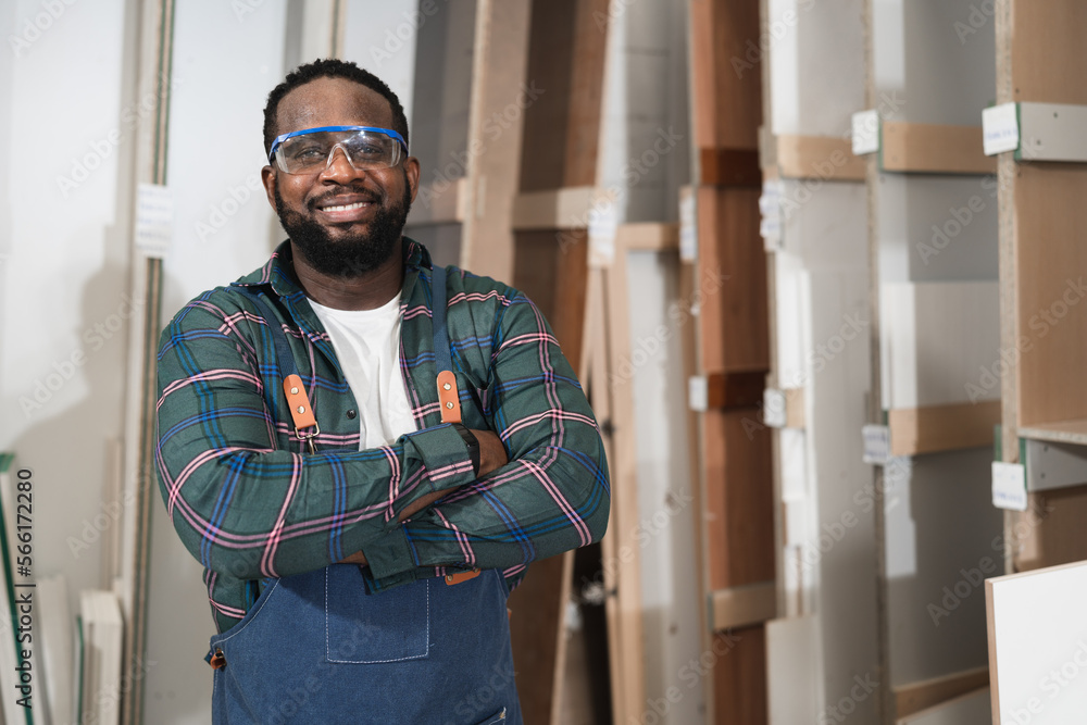 Portrait African American carpenter with wood timber at wood factory