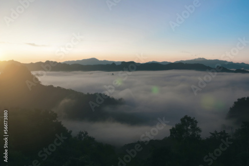 Natural background blurring warm colors and bright sun light. Sky sunny color orange light patterns plain abstract flare evening clouds blur.