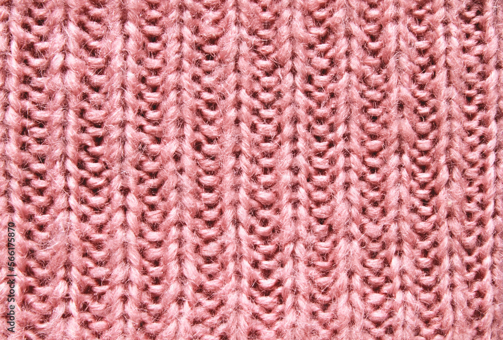 Pink soft chunky woolen sweater surface texture as background
