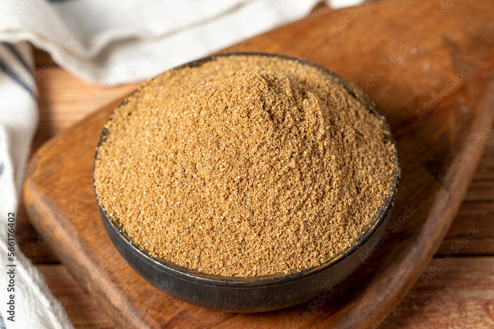 Powdered coriander spice. Coriander powder or dhaniya powder on wooden background. Dry spice concept. close up Powdered coriander spice. Coriander powder or dhaniya powder on wooden background. Dry spice concept. close up
