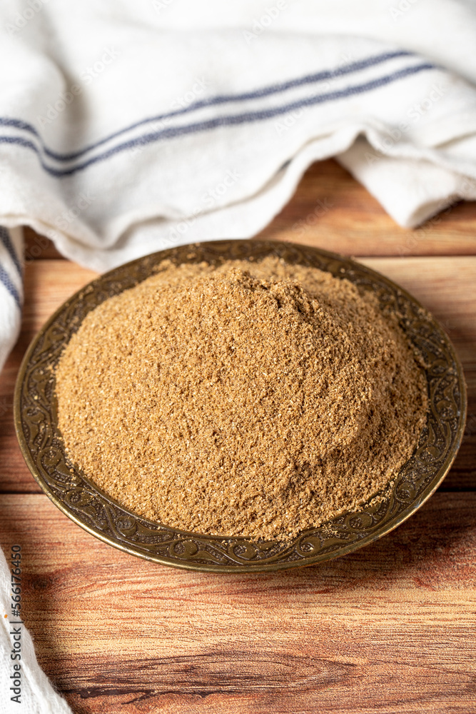 Powdered coriander spice. Coriander powder or dhaniya powder on wooden background. Dry spice concept. close up Powdered coriander spice. Coriander powder or dhaniya powder on wooden background. Dry spice concept. close up