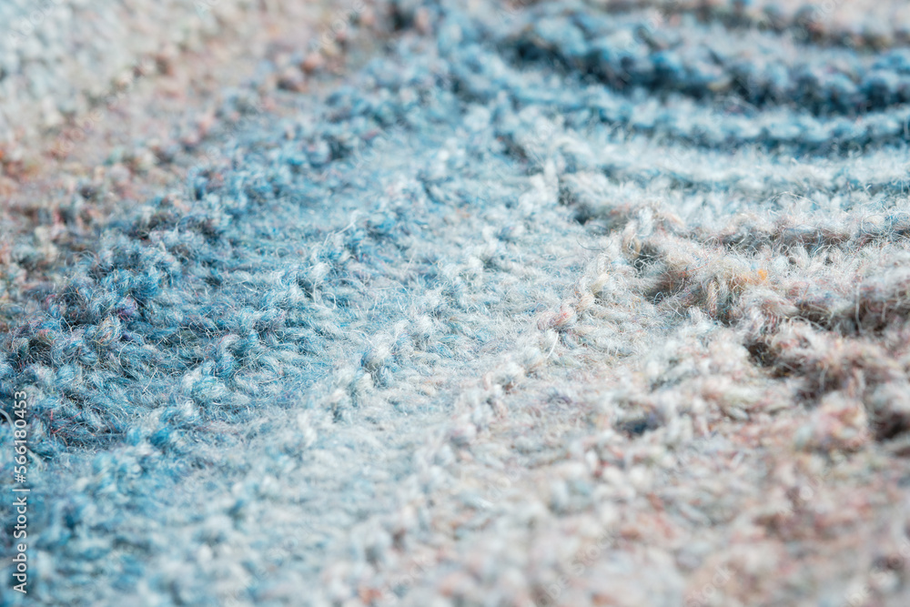 Knitted background. Knitted fabric texture, pure sheep wool, color gradient.