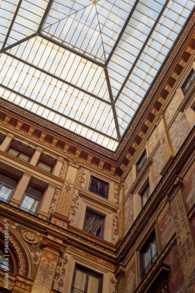 Part of a building and a glass roof in Rome. Windows, walls, facades, ornamentation.