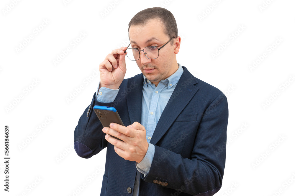 Surprised young businessman holding phone, looking at mobile phone, reading news on white background Surprised young businessman holding phone, looking at mobile phone, reading news on white background