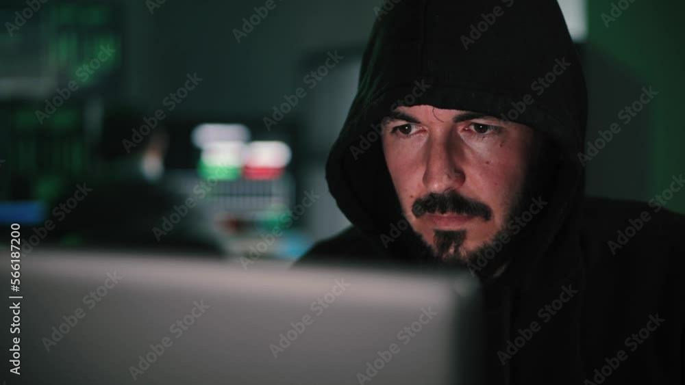 Close up portrait of one hacker looking the screen of a laptop computer, typing the code to breack the security of the firewall on internet. High quality 4k footage Close up portrait of one hacker looking the screen of a laptop computer, typing the code to breack the security of the firewall on internet. High quality 4k footage