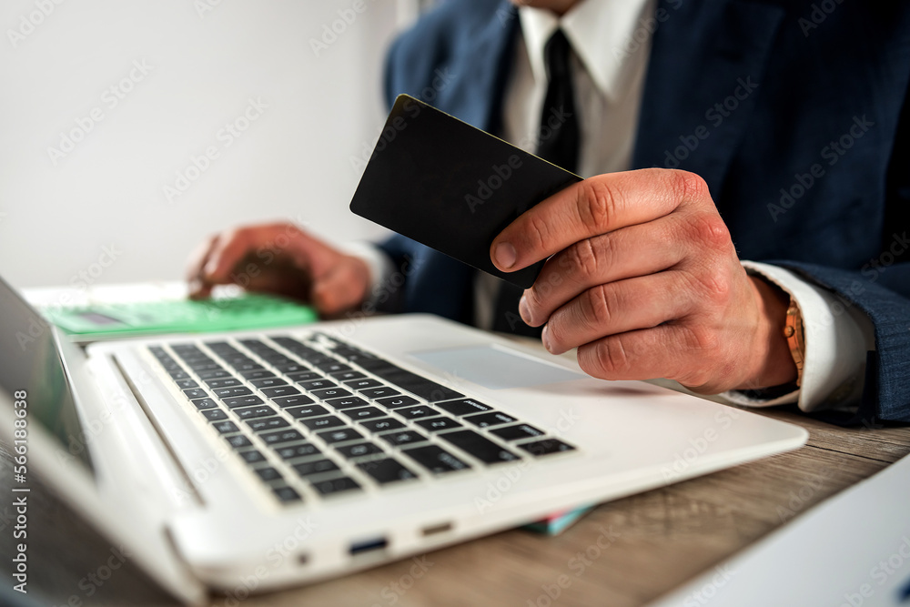 business man holding credit card for online shopping using laptop business man holding credit card for online shopping using laptop